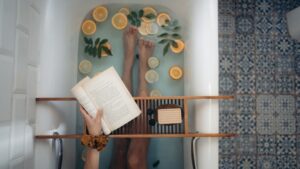 A woman reading a book in a bath